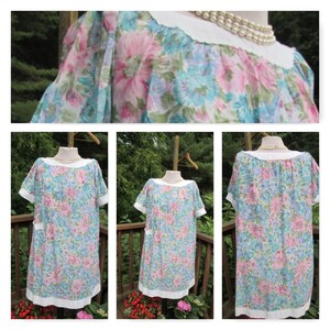 May include: A vintage floral print dress with short sleeves and a white collar. The dress has a loose fit and a gathered neckline. The fabric is a lightweight cotton blend with a blue, pink, and white floral pattern.