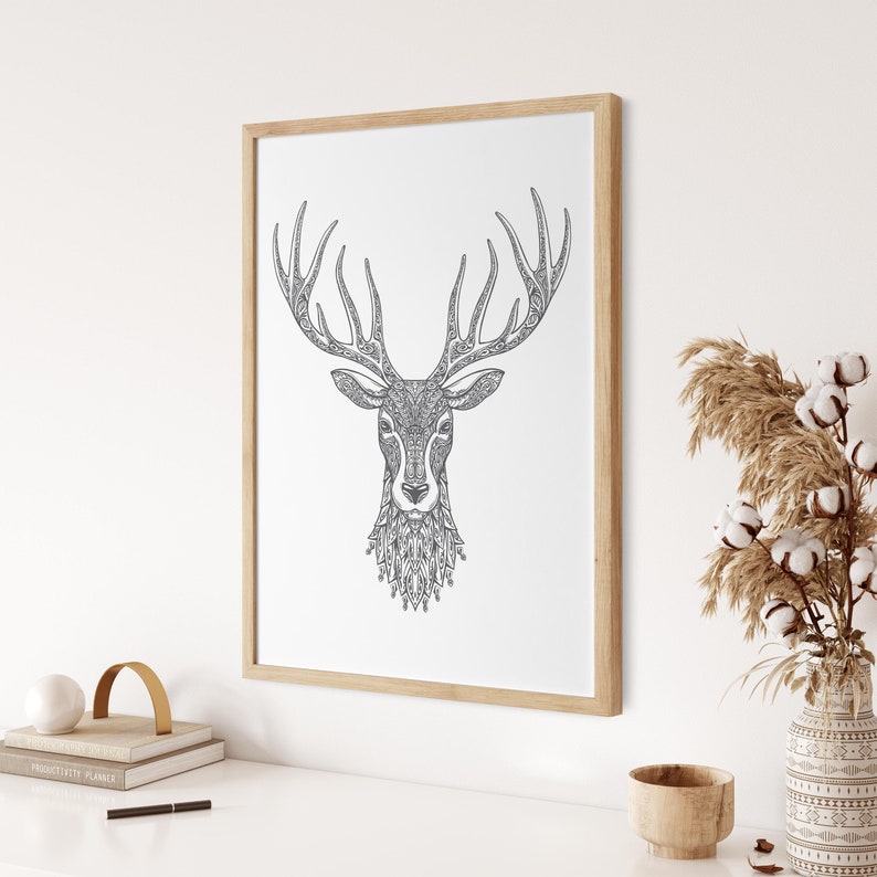 May include: A black and white line drawing of a deer's head with intricate patterns in the antlers and fur. The image is framed in a light wood frame and is hanging on a white wall.