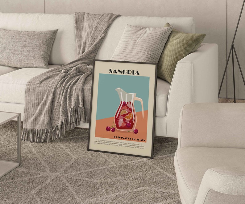 May include: A framed art print featuring a Sangria illustration. The artwork depicts a pitcher filled with red sangria, garnished with orange slices and cherries. The print has the word "Sangria" at the top and "Originates in Spain" at the bottom.