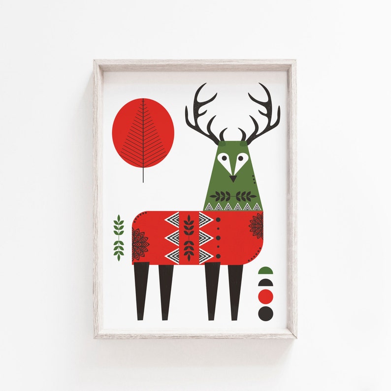 May include: A framed illustration of a stylized deer wearing a red sweater with a geometric pattern. The deer has large antlers and a green body. The background is white with a red circle and green leaves.