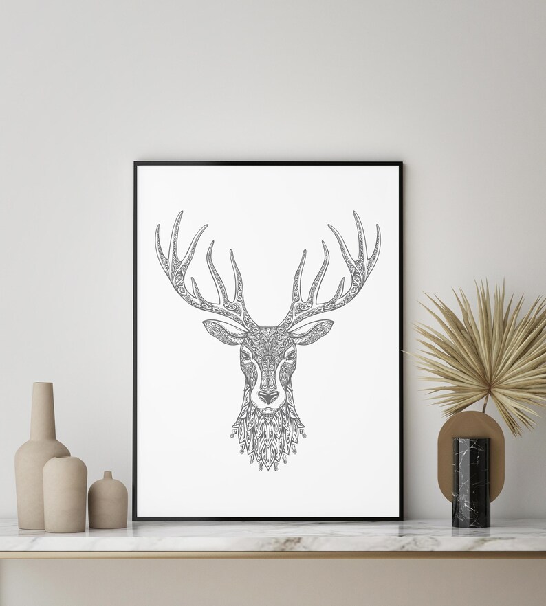 May include: A black and white line art print of a deer's head with intricate patterns in the antlers and fur. The print is framed in a black frame and is hanging on a white wall.
