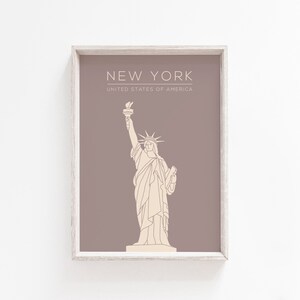 May include: A printable art print with a brown background and a white outline of the Statue of Liberty. The text "NEW YORK" and "UNITED STATES OF AMERICA" is printed in white at the top of the print.