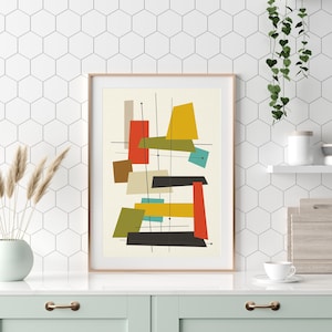 May include: Abstract geometric art print with a white background and colourful shapes in red, yellow, green, blue, and brown. The shapes are arranged in a modern, mid-century style.