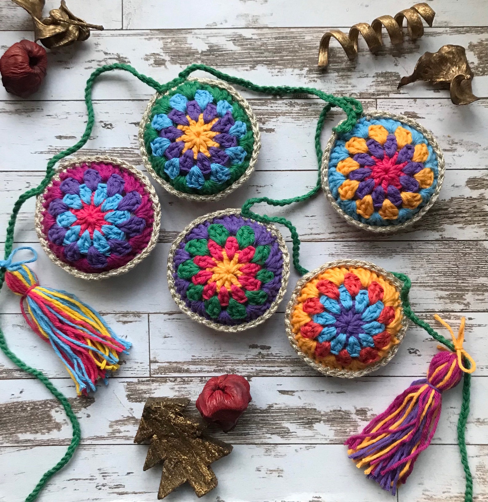 Colorful crochet granny stitch bauble bunting with yarn tassels hanging from a green cord — PDF pattern by TheMayfieldMakery