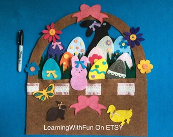 May include: A felt Easter basket with colorful eggs, flowers, and bunny figures. The brown basket has a handle and is decorated with a pink bow and a yellow butterfly. The text "LearningWithFun On ETSY" is at the bottom.