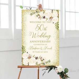 Könnte beinhalten: Goldener Glitzerhintergrund mit weißen Blumen und Grün. Der Text lautet "Willkommen zur 50. Hochzeitstagfeier von Barbara & Frank 50 Jahre Liebe"