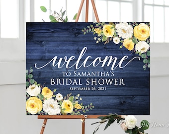May include: A welcome sign for a bridal shower with a navy blue woodgrain background and yellow and white floral accents. The text reads "Welcome to Samantha's Bridal Shower September 26, 2021".