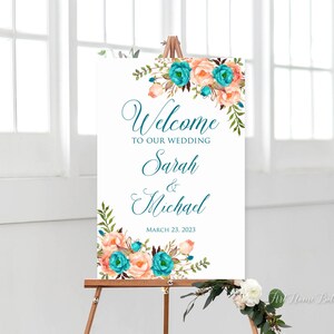 May include: Welcome to our wedding sign with a floral design featuring peach and teal flowers. The sign reads "Welcome to our wedding Sarah & Michael March 23, 2023".