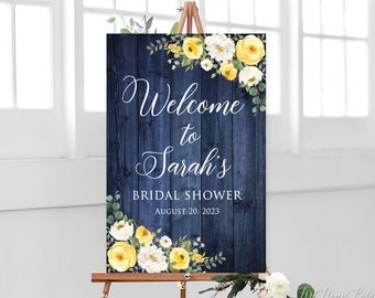 May include: A welcome sign for a bridal shower with a blue woodgrain background and yellow and white flowers. The sign says "Welcome to Sarah's Bridal Shower August 20, 2023".