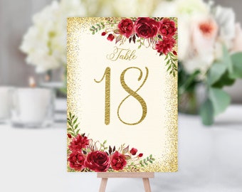 May include: Gold glitter table number card with red floral design and the text "Table 18".