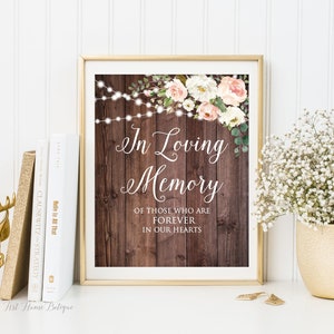 May include: A printable sign with a rustic wood background and floral accents. The sign reads "In Loving Memory of those who are forever in our hearts."
