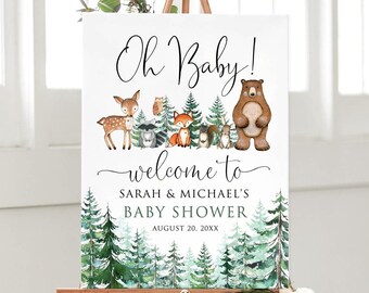 May include: A white welcome sign with the text "Oh Baby!" and "Welcome to Sarah & Michael's Baby Shower August 20, 20XX". The sign features a watercolor illustration of a forest scene with animals including a deer, fox, bear, and owl.