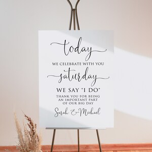 May include: White sign with black calligraphy text that reads "today we celebrate with you saturday we say "I do" thank you for being an important part of our big day Sarah & Michael"