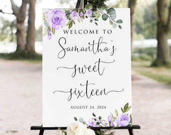 May include: Welcome to Samantha's Sweet Sixteen sign with purple flowers and greenery. The sign is on a black easel and says "Welcome to Samantha's Sweet Sixteen" with the date August 24, 2024.