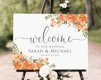 May include: Welcome sign with orange floral design, featuring the text "Welcome to our wedding Sarah & Michael August 26, 2023".