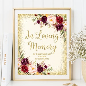 May include: A printable sign with a gold glitter background and burgundy and blush floral accents. The text reads "In Loving Memory Of Those Who Are Forever In Our Hearts".
