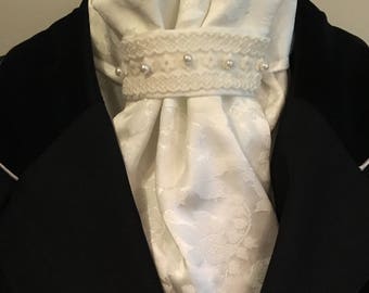 Creamy white satin rose jacquard dressage and stock tie embellished with lace and pearls.