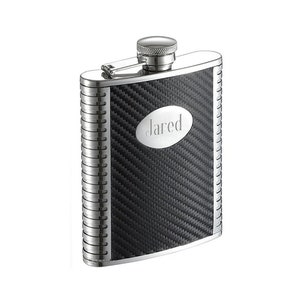 May include: A silver flask with a black carbon fiber pattern and a personalized nameplate that reads "Jared".