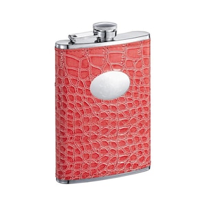 May include: A red faux leather hip flask with a silver top and a silver oval-shaped plate on the front.