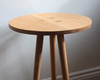 Solid Oak round table with tapered underside to give a fine delicate edge and three turned legs, handmade tapered top table with three legs