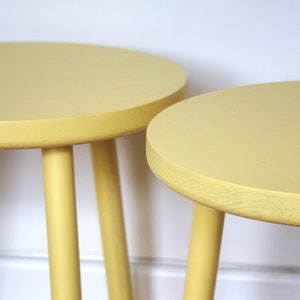 Hand painted round solid European Oak side table with three straight turned legs that are wedge tenon into position painted in F&B eggshell