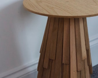 Custom made round side table with a cone shaped base made from layered cedar shingle tiles and solid oak round top with a tapered edge.