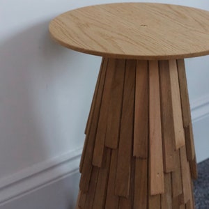 Custom made round side table with a cone shaped base made from layered cedar shingle tiles and solid oak round top with a tapered edge.
