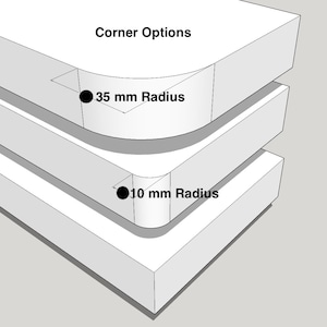 May include: A white 3D diagram titled Corner Options showing two stacked rectangular blocks. The top block features a 35 mm radius corner, while the bottom block features a 10 mm radius corner, both clearly labelled with black text and dots.