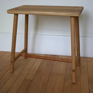 Handmade solid oak table with turned legs and supporting cross members secured that are fixed into position with contrasting wedged tenons