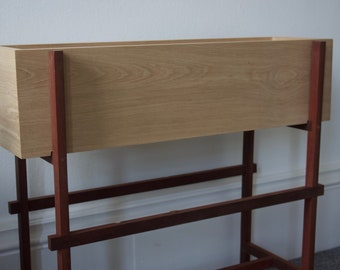 Solid oak indoor planter box with contrasting Sapele leg frame finished in danish oil, custom made oak and Sapele flower stand