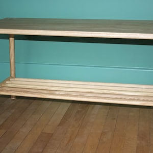 Handmade solid Ash bench seating with turned straight legs fixed with visible contrasting wedged tenons wedges and dowel shoe shelf