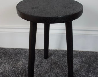 Scorched round oak table with three turned straight legs finished by burning the surface with a blow torch to give a rich deep black finish