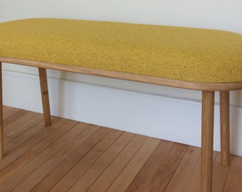 Handmade solid oak bench with rounded ends and four turned straight legs upholstered in 100% recycled chemical free Boucle Fabric