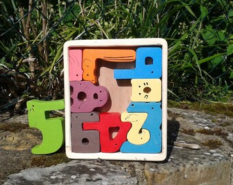 wooden puzzle for learning to count to know... the animals.