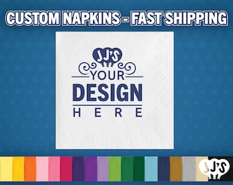 May include: A square white paper napkin featuring a dark blue printed graphic with the text JJ'S YOUR DESIGN HERE. Below the napkin, a horizontal color palette displays various solid color options including yellow, orange, pink, red, purple, green, blue, and black.