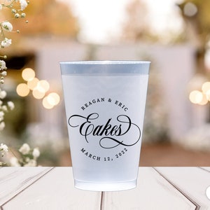 May include: White plastic cup with black text that reads "Reagan & Eric Cakes March 12, 2022".