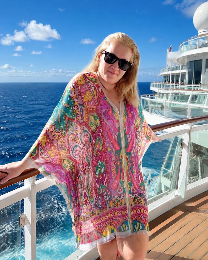 Turquoise pink paisley silk kaftan top worn on a cruise ship deck with ocean view.