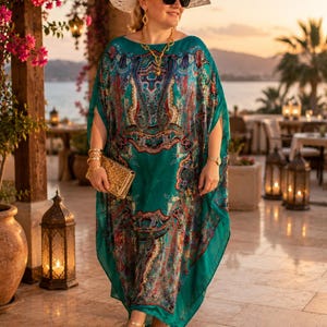 Plus size aquamarine silk kaftan with paisley print styled in a luxury resort, elegant wedding guest dress and beach cover up for tropical holidays.