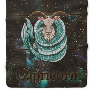 May include: A black and blue fleece blanket with a galaxy print and a stylized illustration of a Capricorn zodiac sign. The sign is a goat with a fish tail, surrounded by a triangle and the symbol for Capricorn. The text "Capricorn" is written below the sign.