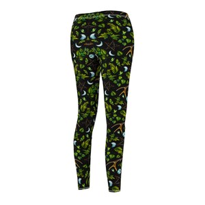 May include: Black leggings with a repeating pattern of green leaves, crescent moons, pentagrams, and antlers.