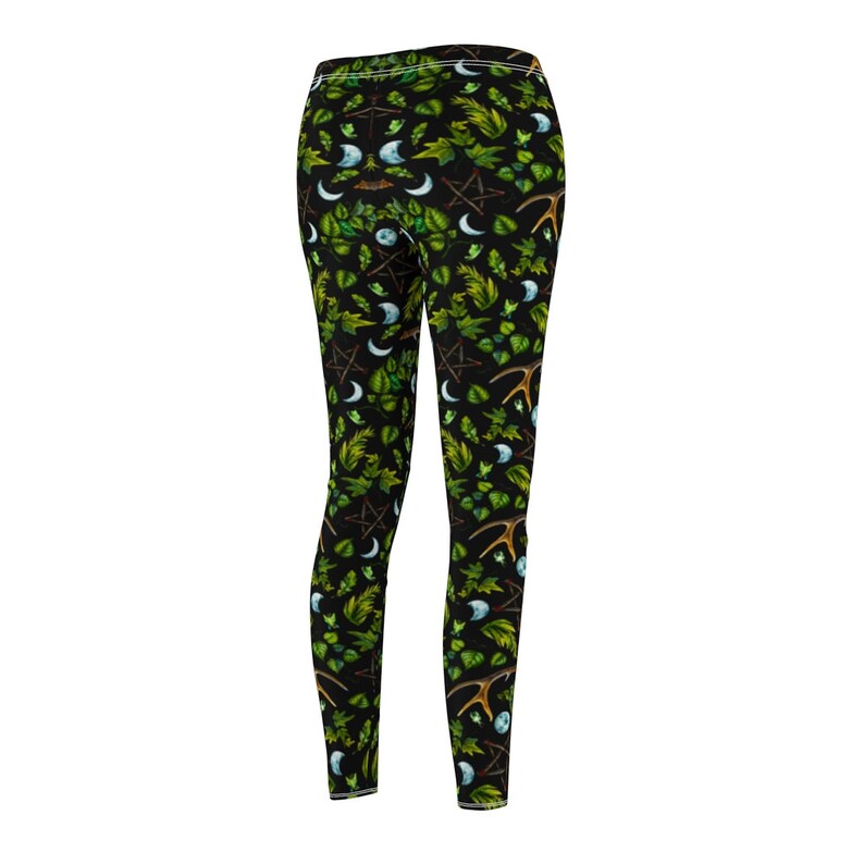 May include: Black leggings with a repeating pattern of green leaves, crescent moons, pentagrams, and antlers.