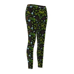 May include: Black leggings with a green, white, and brown pattern of leaves, moons, and pentagrams.