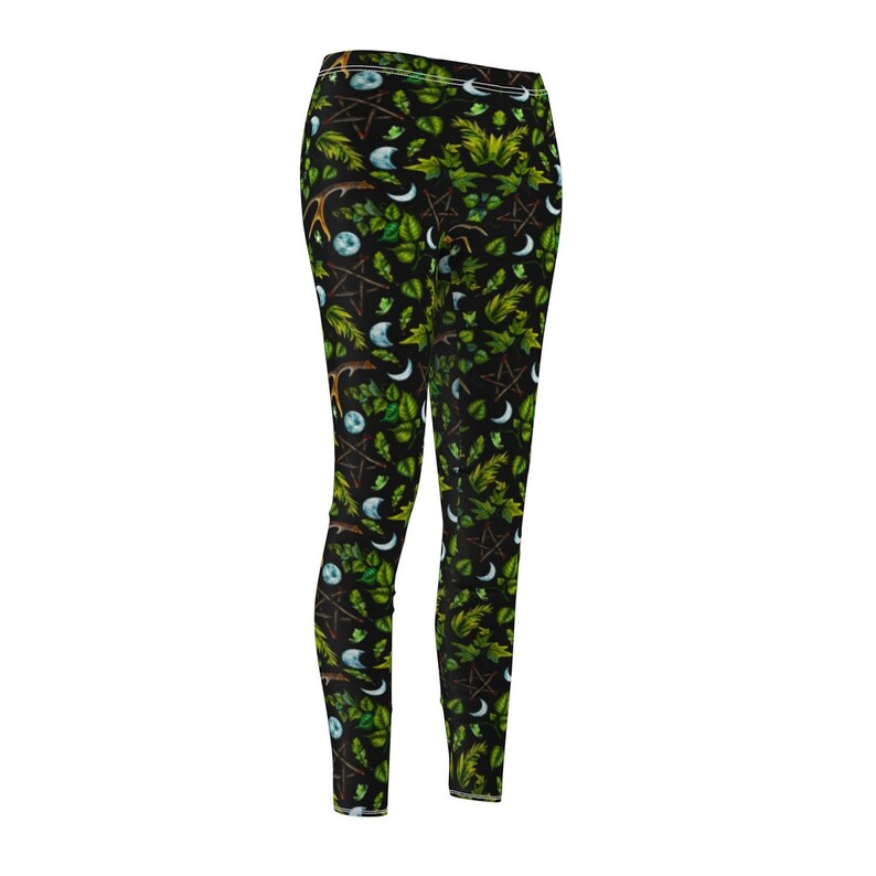 May include: Black leggings with a green, white, and brown pattern of leaves, moons, and pentagrams.