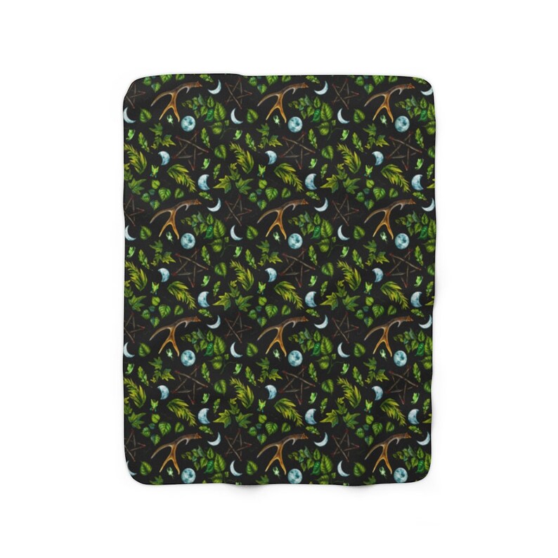 May include: A black and green patterned fleece blanket with a repeating design of antlers, crescent moons, pentacles, and leaves.