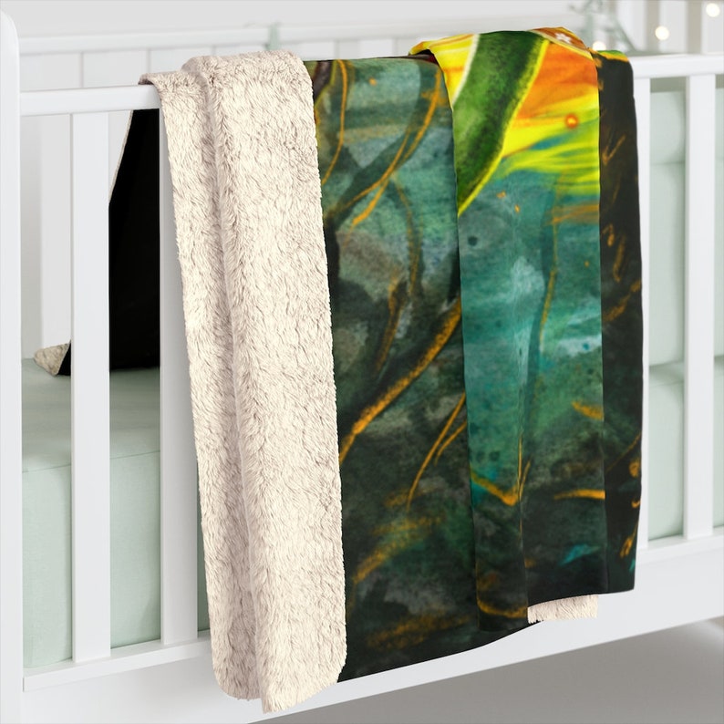 May include: A soft, plush throw blanket with a colorful abstract design featuring shades of green, yellow, and blue. The blanket has a white sherpa backing.