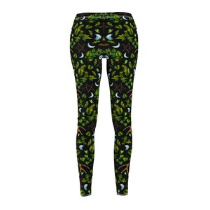 May include: Black leggings with a repeating pattern of green leaves, crescent moons, pentagrams, and antlers.