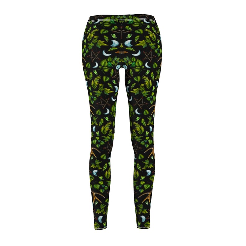 May include: Black leggings with a repeating pattern of green leaves, crescent moons, pentagrams, and antlers.
