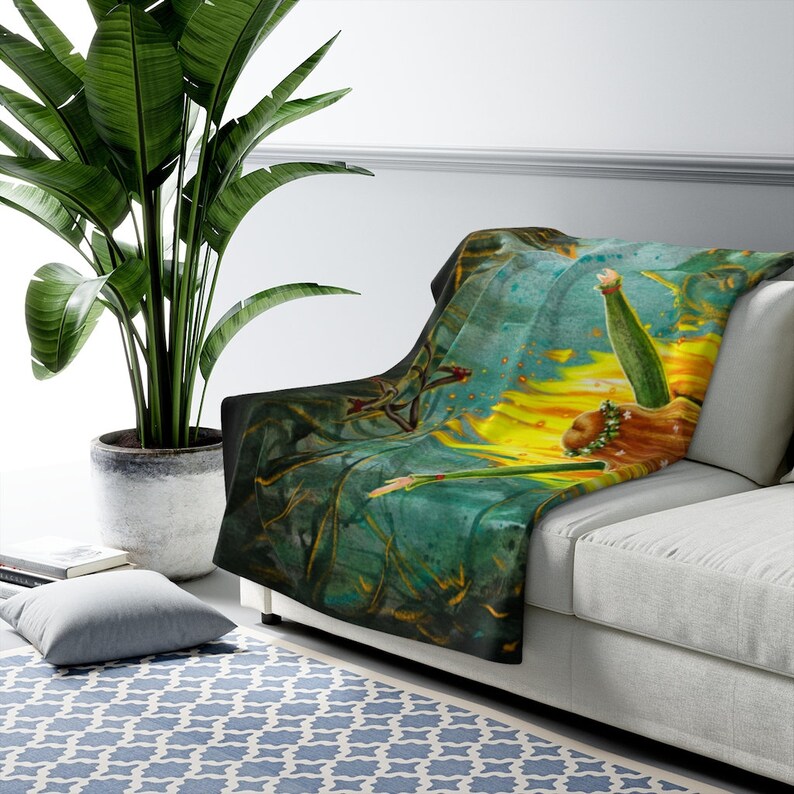 May include: A soft, plush throw blanket featuring a watercolor painting of a woman with flowing red hair, reaching up towards a bright yellow sun. The background is a mix of green, blue, and yellow hues.
