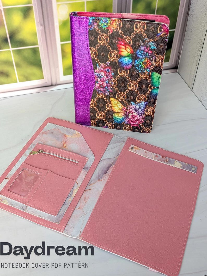 May include: A pink notebook cover with a butterfly and floral design. The cover features a brown background with gold chain links and colorful butterflies. The interior is pink with pockets and a zipper. The text "Daydream" and "NOTEBOOK COVER PDF PATTERN" are visible.