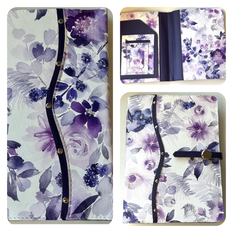 May include: A white and purple floral patterned journal cover with a dark blue spine and snap closure. The cover features a watercolor design of purple flowers and foliage. The journal is shown closed, open, and with an interior pocket.